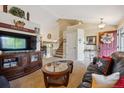 Inviting living room showcasing open layout, staircase, and stylish furnishings for modern living at 23634 Broadmoor Dr, Parker, CO 80138