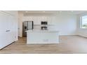 Kitchen features stainless steel appliances, center island, and white cabinetry at 1284 S Algonquian St, Aurora, CO 80018