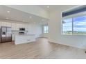 Open floor plan features stainless steel appliances, kitchen island, and bright windows at 1284 S Algonquian St, Aurora, CO 80018