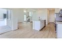 Open floor plan with bright living room, kitchen island, and stainless steel appliances at 1284 S Algonquian St, Aurora, CO 80018