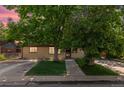 Charming home featuring a well-manicured lawn, beautiful mature trees, and a welcoming front entrance at 2518 S Patton Ct, Denver, CO 80219