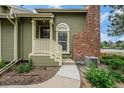 Inviting home featuring a covered porch, brick detail, and a walkway at 1915 S Hannibal St # G, Aurora, CO 80013
