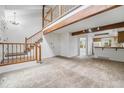 Spacious living area with a staircase, wood beam and adjoins the kitchen at 1915 S Hannibal St # G, Aurora, CO 80013