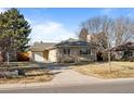 Ranch home with attached garage and a well-manicured lawn at 2885 Hudson St, Denver, CO 80207