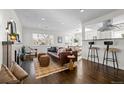 Modern living room with a fireplace, hardwood floors, and open concept design at 2885 Hudson St, Denver, CO 80207