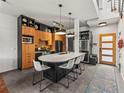 This modern kitchen has a large island with seating, sleek countertops, and stainless steel appliances at 3133 Blake St # 3, Denver, CO 80205