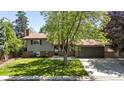 Charming home with brick accents, neutral siding, mature landscaping, and an attached two car garage at 1250 Acropolis Dr, Lafayette, CO 80026