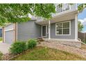 Home featuring fresh, neutral paint, a covered entryway, and green landscaping at 15762 Olmsted Pl, Denver, CO 80239