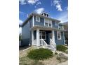 Beautiful home with a blue exterior, white trim and front porch at 4689 Tanner Peak Trl, Brighton, CO 80601