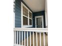 Inviting covered porch with a bright entry door and matching trim at 4689 Tanner Peak Trl, Brighton, CO 80601