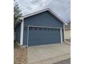 Detached two-car garage with matching siding at 4689 Tanner Peak Trl, Brighton, CO 80601