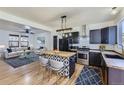 Open floor plan featuring a modern kitchen with stainless steel appliances and a decorative center island at 4689 Tanner Peak Trl, Brighton, CO 80601