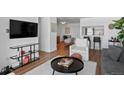 Living room features hardwood floors, a large TV, and comfortable seating at 2 Adams St # 1401, Denver, CO 80206