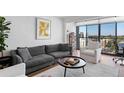 Spacious living room with hardwood floors, large windows, and city views at 2 Adams St # 1401, Denver, CO 80206