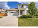 Inviting two-story house with stone accents, a neat lawn, and a two-car garage for comfortable living at 24748 E Layton Pl, Aurora, CO 80016