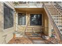 Exterior entrance featuring a covered porch with unique tile flooring and convenient stair access at 980 S Dahlia St # A, Denver, CO 80246