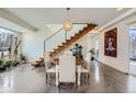Bright dining area features modern lighting, a staircase, and a contemporary design at 4795 Highline Pl, Denver, CO 80222