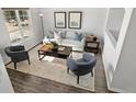 Living room with hardwood floors and comfortable seating at 16530 Timber Cove St, Hudson, CO 80642