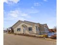 Charming exterior view of a townhome with an accessible ramp and well-maintained landscaping in a suburban neighborhood at 12292 E 2Nd Dr, Aurora, CO 80011