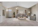 Bright living room featuring vaulted ceilings, a ceiling fan, and neutral-toned furniture for a cozy and inviting atmosphere at 12292 E 2Nd Dr, Aurora, CO 80011