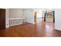 Spacious dining area with hardwood floors, stylish chandelier, and staircase at 4627 S Norfolk Way, Aurora, CO 80015
