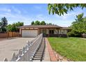 Traditional home boasts mature landscaping and a walkway leading to the front door at 4627 S Norfolk Way, Aurora, CO 80015