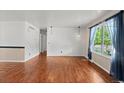 Bright living room with hardwood floors, neutral walls, and pendant lighting at 4627 S Norfolk Way, Aurora, CO 80015