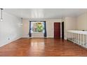 Spacious living room showcasing gleaming hardwood floors and a large window at 4627 S Norfolk Way, Aurora, CO 80015