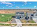Aerial view of a two-story home showcasing its landscaping and surrounding neighborhood at 5805 Red Barn Ave, Longmont, CO 80504