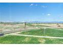 Scenic view from a window overlooking a field, with mountains visible in the distance at 5805 Red Barn Ave, Longmont, CO 80504