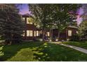 Attractive brick residence with manicured lawn and trees providing shade at 6940 Saddleback Ave, Firestone, CO 80504