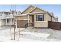 Charming single-Gathering home featuring a stone-accented facade and attached two-car garage at 9673 Ceylon St, Commerce City, CO 80022
