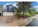 Charming two-story home featuring a spacious driveway and a beautiful mature tree in the front yard at 10370 Routt St, Westminster, CO 80021