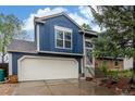 A well-maintained two-story home with a two-car garage, complemented by landscaped surroundings at 10370 Routt St, Westminster, CO 80021