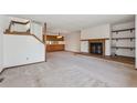 Bright living room with open layout, fireplace, and staircase to the second floor at 2715 Northbrook Pl, Boulder, CO 80304