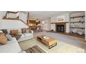 Cozy living room features a fireplace and open floor plan connecting to the dining area at 2715 Northbrook Pl, Boulder, CO 80304