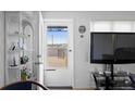 Bright living area showcasing a glass storm door and modern decor at 4849 N Cook St, Denver, CO 80216