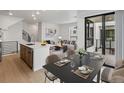 Stylish dining area adjoining the kitchen with modern table setting and balcony access to an outdoor living area at 2042 S Holly St # 3, Denver, CO 80222