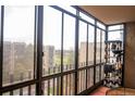 Enclosed balcony with floor to ceiling windows and view of surrounding buildings and greenery at 14091 E Marina Dr # 612, Aurora, CO 80014