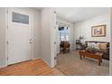 Bright entryway with wood floors and a view into a cozy sitting area at 39260 Braxton Ln, Elizabeth, CO 80107