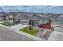 Attractive single story home featuring a three car garage, stone accents, and a manicured front lawn with a tree at 7646 Greenwater Cir, Castle Rock, CO 80108