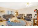 Living room with oversized furniture, ceiling fan, and an area rug adding warmth and charm at 13902 E Marina Dr # 111, Aurora, CO 80014