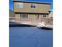 A spacious wooden back deck is covered in snow, leading to the house's rear entrance and backyard at 3610 Morning Glory Dr, Castle Rock, CO 80109