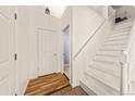 Bright entryway with tile floors, white walls, and a staircase leading to the upper level at 21562 E 47Th Ave, Denver, CO 80249