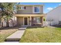 Charming two-story home with front porch, landscaped yard and a well-maintained lawn at 21562 E 47Th Ave, Denver, CO 80249