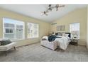 Serene main bedroom with vaulted ceilings, plush carpet, and a bench at the foot of the bed at 14025 Blue River Trl, Broomfield, CO 80023