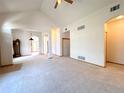 Expansive living area with high ceilings, archways, neutral walls, and carpet floors at 3231 E 102Nd Pl, Thornton, CO 80229