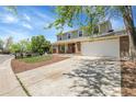 Charming two-story home with a brick facade, well-maintained lawn, and attached two car garage at 3653 E 133Rd Ct, Thornton, CO 80241