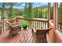 Cozy balcony featuring comfortable wicker chairs, a small table with plant, and scenic mountain views at 322 Davis Ct, Breckenridge, CO 80424