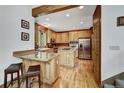 Well-equipped kitchen with light wood cabinets, granite countertops, stainless steel appliances, and hardwood floors at 322 Davis Ct, Breckenridge, CO 80424